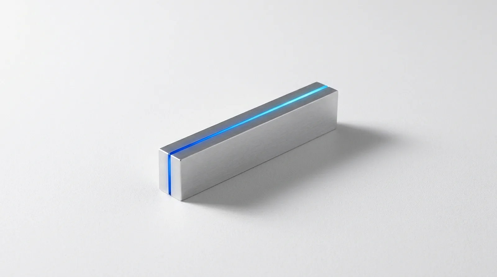 A sealed aluminium volume with a single unbroken thread of light running the length of its seam.