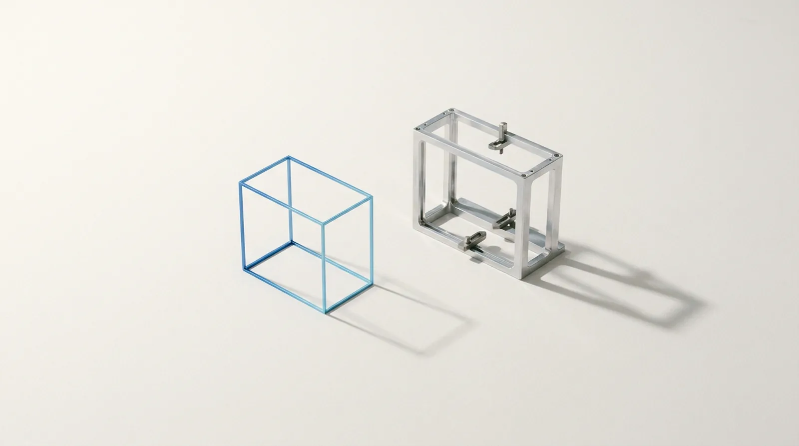 A skeletal wireframe model with no surfaces, standing beside the empty jig it would be formed in.